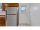 Kitchen with stainless steel refrigerator and back door with blinds at 1324 W 15Th St, Tempe, AZ 85281