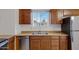 Kitchen featuring a stainless steel dishwasher, sink, and wood cabinets at 1324 W 15Th St, Tempe, AZ 85281