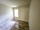 Bedroom featuring wood-look floors and a window for natural light at 1331 W Baseline Rd # 152, Mesa, AZ 85202