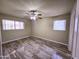 Bedroom featuring wood-look floors, ceiling fan and two windows for ample natural light at 1331 W Baseline Rd # 152, Mesa, AZ 85202