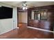 Living room showcasing wood floors, ceiling fan and a pass through to the kitchen at 1331 W Baseline Rd # 152, Mesa, AZ 85202