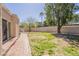 Lush backyard with brick pavers and mature trees, ideal for outdoor enjoyment at 14266 N 2Nd Ave, Phoenix, AZ 85023