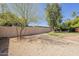 Desert landscaped backyard offering a serene environment with mature trees at 14266 N 2Nd Ave, Phoenix, AZ 85023