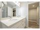 Bright bathroom featuring a double vanity with stone countertop and a walk-in closet at 14266 N 2Nd Ave, Phoenix, AZ 85023