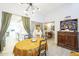 Bright dining room with wood look tile flooring and access to the kitchen at 14266 N 2Nd Ave, Phoenix, AZ 85023