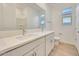 Bright bathroom featuring double vanity and a large mirror at 14770 W Tether Trl, Surprise, AZ 85387