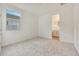 Neutral bedroom with carpet, a window, and an ensuite bathroom at 14770 W Tether Trl, Surprise, AZ 85387