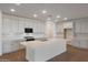 Modern kitchen featuring white cabinets, quartz countertops, stainless steel appliances, and a large center island at 14790 W Tether Trl, Surprise, AZ 85387