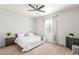 Bedroom with plush carpet, ceiling fan, and natural light from a large window at 15252 N 100Th St # 1156, Scottsdale, AZ 85260