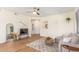 Bright living room featuring wood floors, ceiling fan, and neutral-colored sectional sofa at 15252 N 100Th St # 1156, Scottsdale, AZ 85260