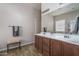 Bright bathroom with dual sinks, vanity, large mirror, and ample counter space at 16492 N 181St Dr, Surprise, AZ 85388