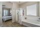 Well-lit bathroom featuring a glass-enclosed shower, separate soaking tub, and neutral color palette at 16492 N 181St Dr, Surprise, AZ 85388