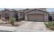 Attached two-car garage with neutral color door and desert landscaping at 16492 N 181St Dr, Surprise, AZ 85388