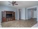 Spacious living room featuring wood-look tile flooring and a large entertainment center at 16492 N 181St Dr, Surprise, AZ 85388