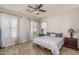 Serene main bedroom with ceiling fan, wood look tile floors, and plenty of natural light at 16492 N 181St Dr, Surprise, AZ 85388