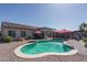 Aerial view of backyard with inviting pool, shaded gazebo, covered patio, and desert landscape at 16492 N 181St Dr, Surprise, AZ 85388