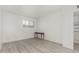 Neutral bedroom showcasing wood-look floors, and a large window for plenty of natural light at 1702 W Tuckey Ln # 124, Phoenix, AZ 85015