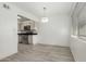 Kitchen and living room with sleek floors, open layout, and recessed lighting at 1702 W Tuckey Ln # 124, Phoenix, AZ 85015