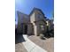 Two-story home featuring a stucco exterior, arched entryway, and low-maintenance gravel landscaping at 1709 W Pollack St, Phoenix, AZ 85041