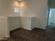 Neutral hallway with carpet, white walls, and small window allowing for natural light at 1709 W Pollack St, Phoenix, AZ 85041