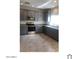 Modern kitchen with gray cabinets, stainless steel appliances and granite countertops at 1709 W Pollack St, Phoenix, AZ 85041