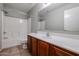 This bathroom features tiled floors, a white vanity, and a tub-shower combo at 17474 W Acapulco Ln, Surprise, AZ 85388