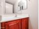 Cozy bathroom with warm-toned vanity, clean white sink, and well-lit mirror at 17474 W Acapulco Ln, Surprise, AZ 85388