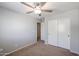 Bedroom with a large closet, carpet and a ceiling fan at 17474 W Acapulco Ln, Surprise, AZ 85388