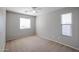 Carpeted bedroom with window, a ceiling fan, and neutral colored walls at 17474 W Acapulco Ln, Surprise, AZ 85388