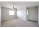 This bright bedroom offers neutral walls, carpet, a ceiling fan, and ample natural light at 17474 W Acapulco Ln, Surprise, AZ 85388