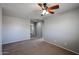 This bedroom provides neutral walls, carpet, and ample space, leading to additional rooms at 17474 W Acapulco Ln, Surprise, AZ 85388