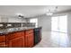 Kitchen featuring granite countertops, wooden cabinetry, stainless steel sink, and modern appliances at 17474 W Acapulco Ln, Surprise, AZ 85388