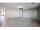 Spacious living room area with neutral carpet and ceiling fan at 17474 W Acapulco Ln, Surprise, AZ 85388