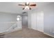 Second floor loft with neutral walls, carpet flooring, and a closet at 17474 W Acapulco Ln, Surprise, AZ 85388