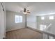 Upstairs loft with neutral walls, carpet flooring, and white railing at 17474 W Acapulco Ln, Surprise, AZ 85388