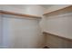 Spacious walk-in closet with shelving and hanging rods for ample storage at 17474 W Acapulco Ln, Surprise, AZ 85388