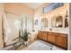 Bright bathroom with double vanity, soaking tub, shower, and natural light from an awning window at 1966 E Drake Dr, Tempe, AZ 85283