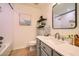 Bright bathroom with new vanity, full mirror and shower with tile surround and storage shelves at 1966 E Drake Dr, Tempe, AZ 85283