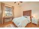 Bedroom features bright walls, wood flooring, a writing desk, a ceiling fan and a large window at 1966 E Drake Dr, Tempe, AZ 85283