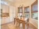 Charming breakfast nook featuring a wooden table, four chairs, natural light, and tiled flooring at 1966 E Drake Dr, Tempe, AZ 85283