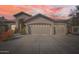 Stunning home showcasing an oversized three car garage as dusk begins to fall at 1966 E Drake Dr, Tempe, AZ 85283