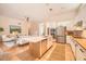 Modern kitchen with stainless steel appliances, white cabinetry, and center island, seamlessly connected to the living room at 1966 E Drake Dr, Tempe, AZ 85283