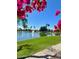 Scenic view of the community lake featuring a fountain, lush green lawns, and flowering plants at 1966 E Drake Dr, Tempe, AZ 85283