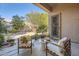 Inviting covered patio with comfortable seating, a table with flowers, and desert landscaping at 1966 E Drake Dr, Tempe, AZ 85283