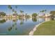 Scenic view of a community pond with palm trees, fountains, and well-maintained landscaping at 1966 E Drake Dr, Tempe, AZ 85283