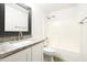 Bright bathroom featuring a granite countertop, framed mirror, and a shower over the tub at 22610 N 17Th St, Phoenix, AZ 85024