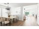 Bright dining area featuring a modern chandelier, a large table, and an open floor plan at 22610 N 17Th St, Phoenix, AZ 85024