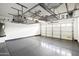 Clean garage with painted floor, overhead storage racks, and an insulated garage door at 22610 N 17Th St, Phoenix, AZ 85024