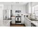 Modern kitchen featuring white cabinets, granite countertops, and stainless steel appliances at 22610 N 17Th St, Phoenix, AZ 85024