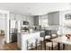 Well-lit kitchen with stainless steel appliances, an island with seating, and shaker-style cabinets at 22610 N 17Th St, Phoenix, AZ 85024